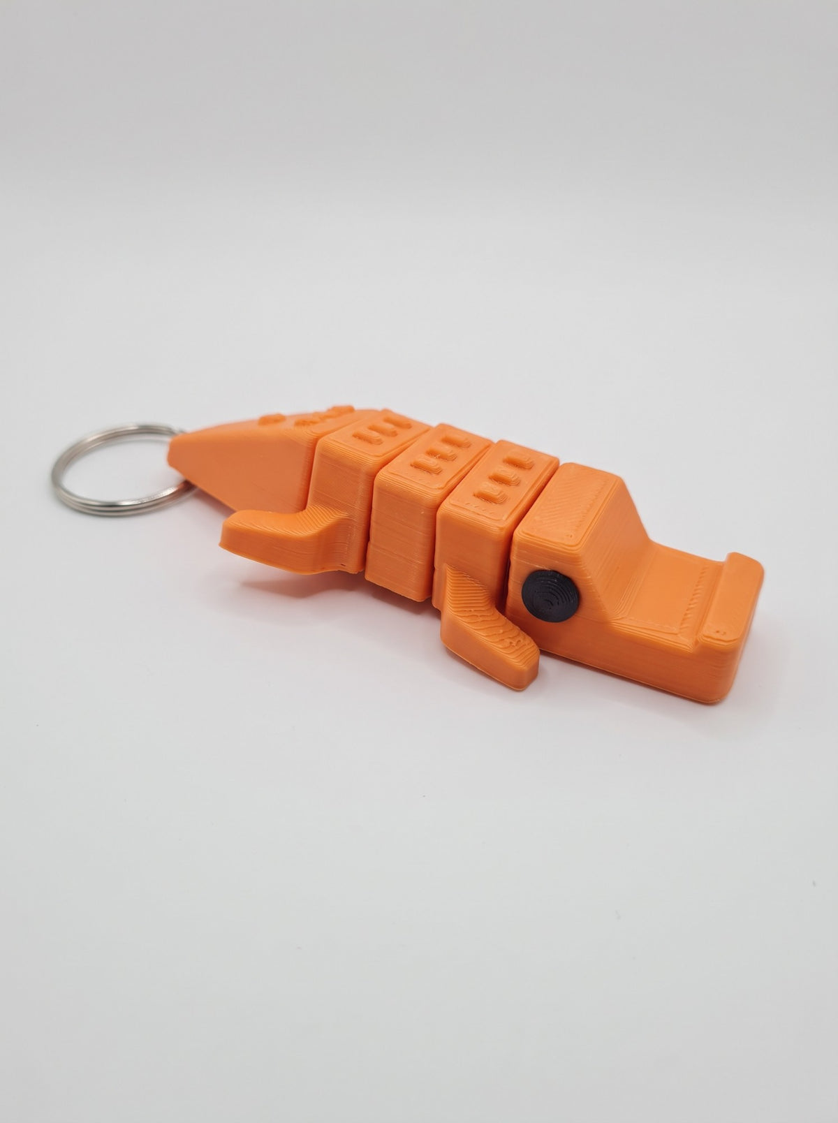 Cocodrilo articulado 3D naranja en forma de llavero