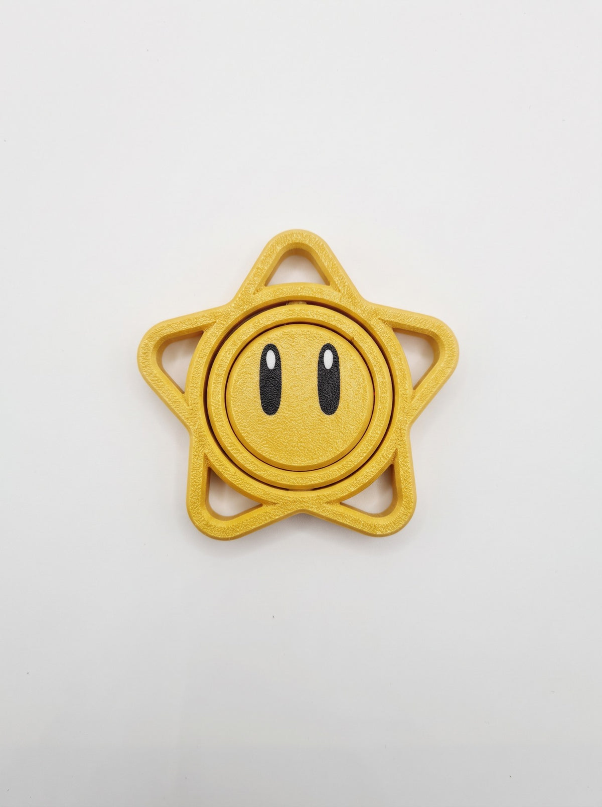 Spinner estrella 3D amarilla con carita