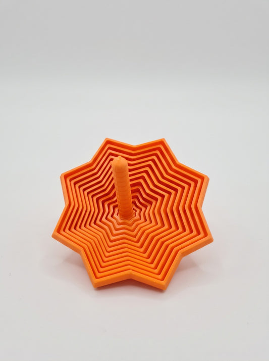 Trompo espiral 3D naranja con base en forma de estrella